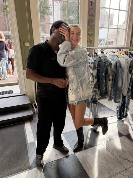 A cheerful moment is captured indoors at Westermarkt, Centrum, Amsterdam, showing two people playfully posing for the camera